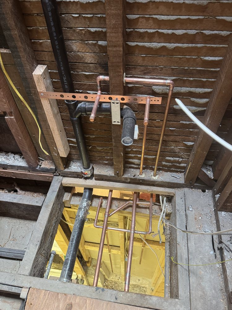 Copper and PEX supply lines routed through attic framing in Yuma, AZ